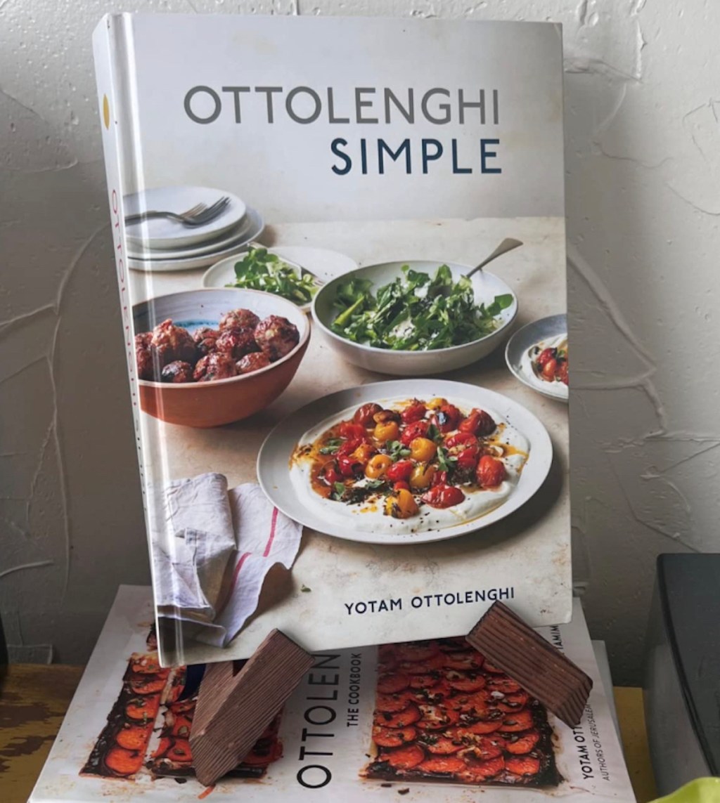 wooden cookbook stand with cookbook on top 