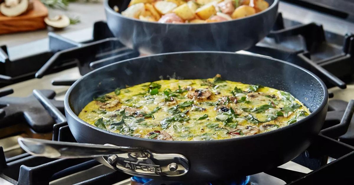 All clad skillets on a stove cooking food