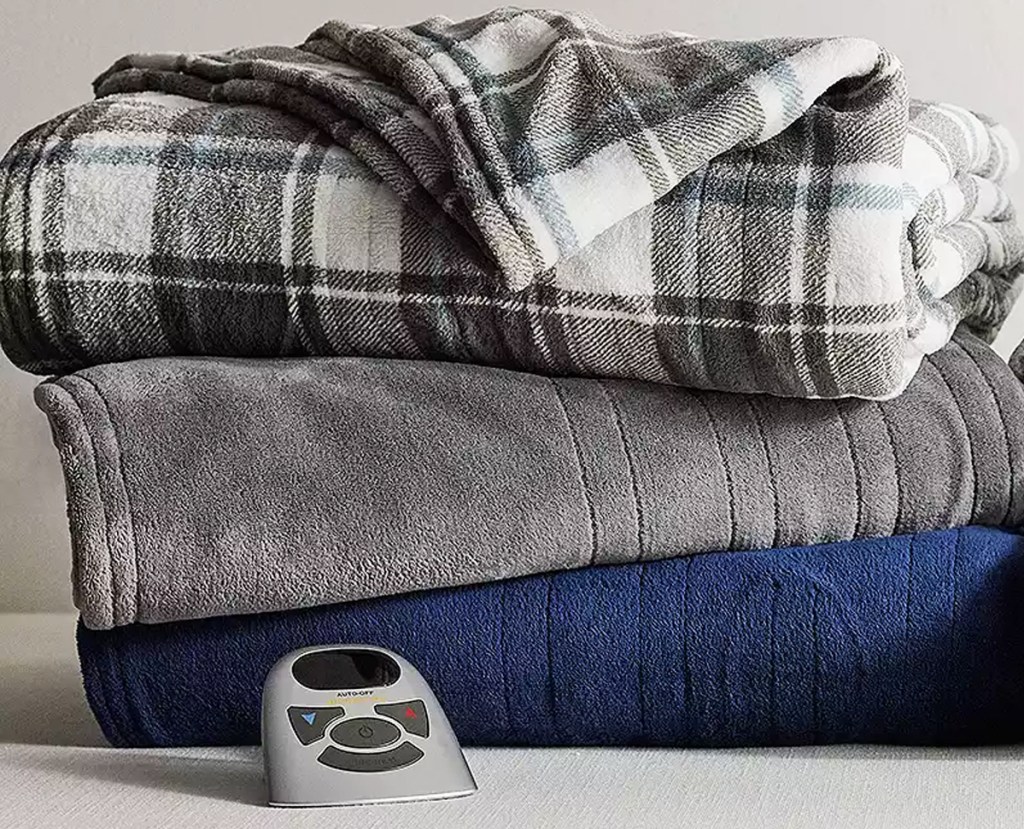 stacked plaid, grey, and navy blue heated blankets