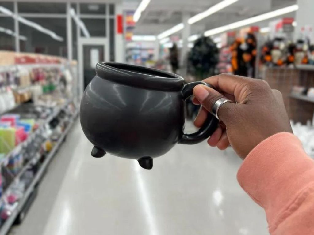 A hand holding a Cauldron Mug