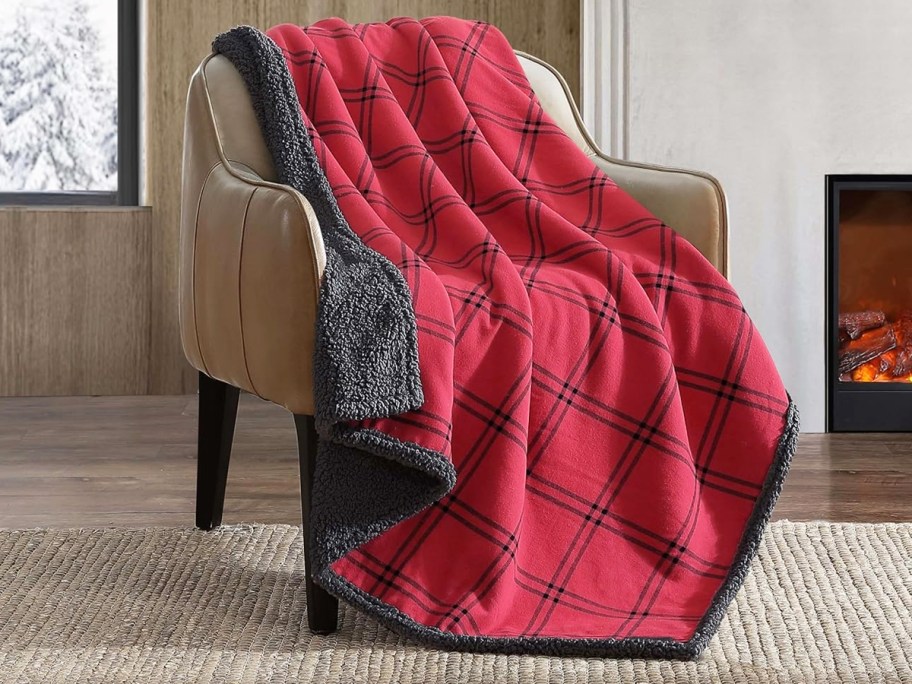 red and black plaid throw blanket draped over a chair