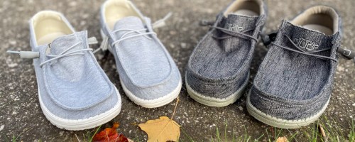 Pairs of Hey Dude shoes in the grass