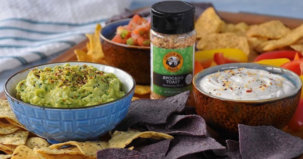 Einstein Bros. Bagels Avocado Toast Seasoning 5.4oz Bottle shown with dip, guac and chips