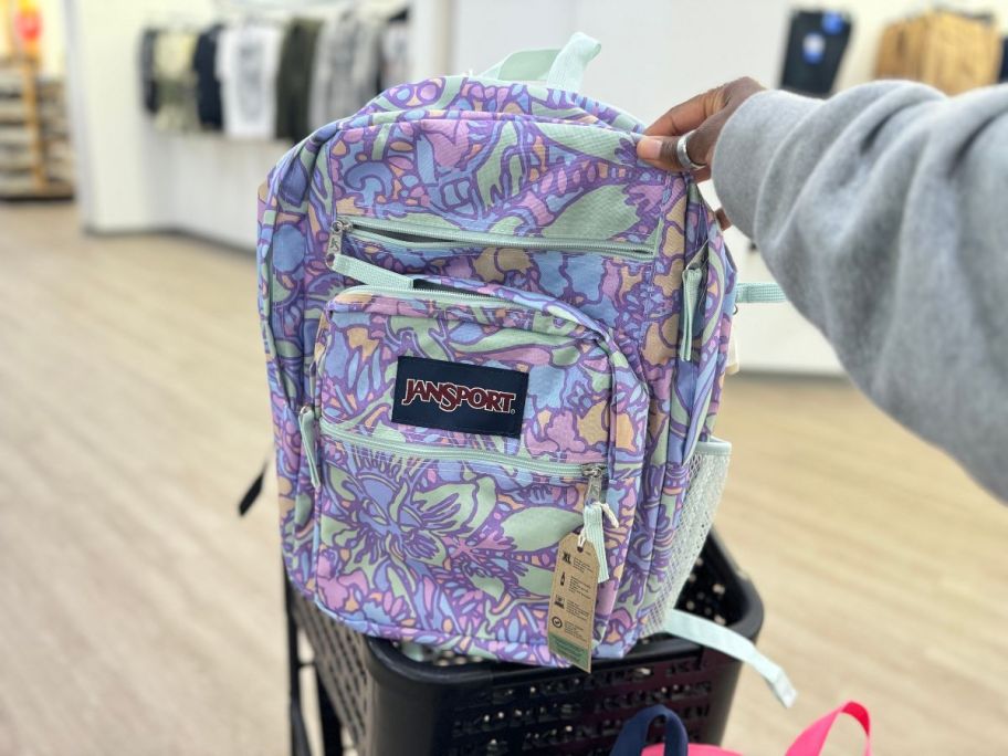 JanSport Big Student Backpack in Floral Lilac in hand in store