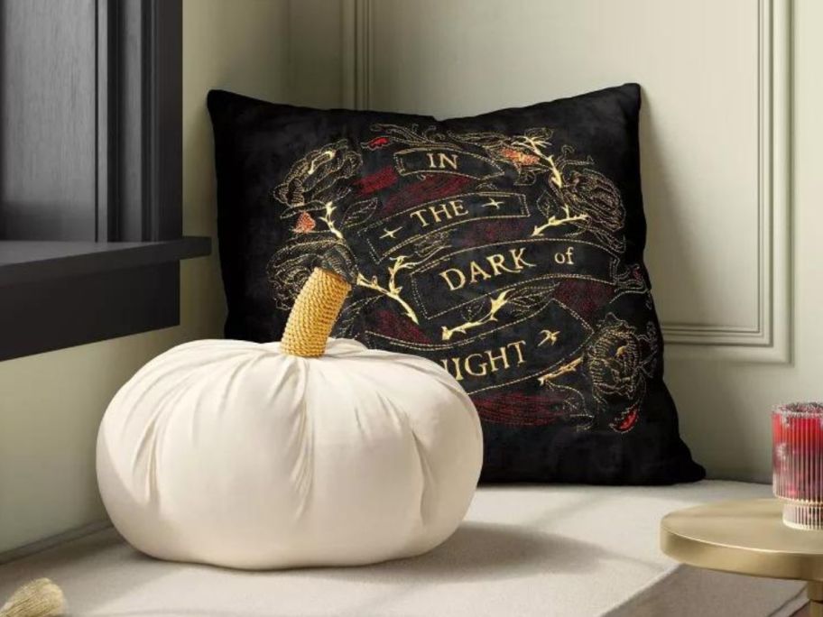 black velvet and cream pumpkin pillows on bench