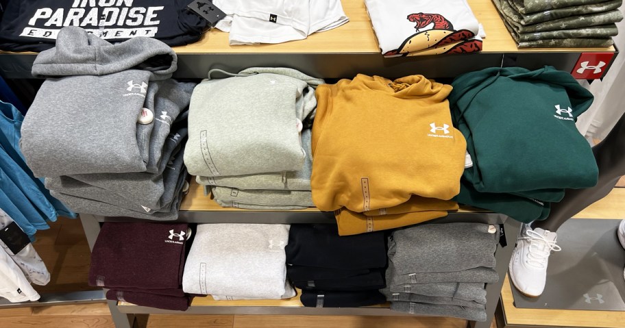 store display rack with folded under armour hoodies