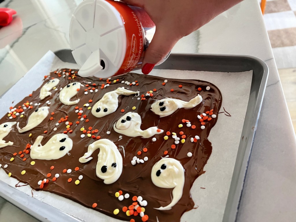 adding sprinkles to ghost bark