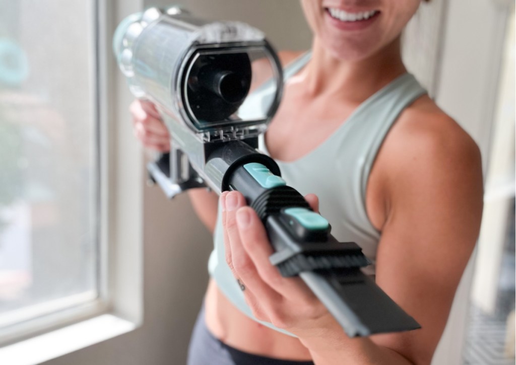 woman holding handheld vacuum