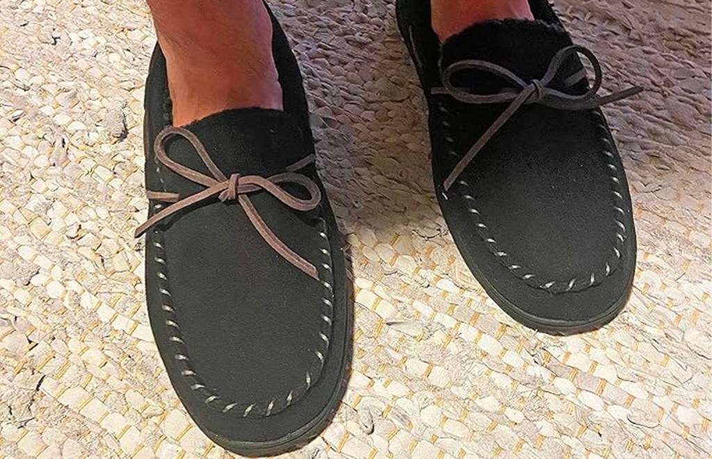 man wearing black dearfoam mocassin slippers