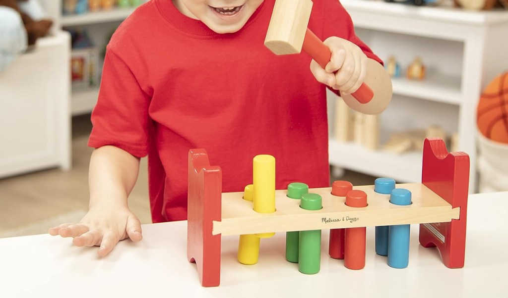 kid playing with hammer toy