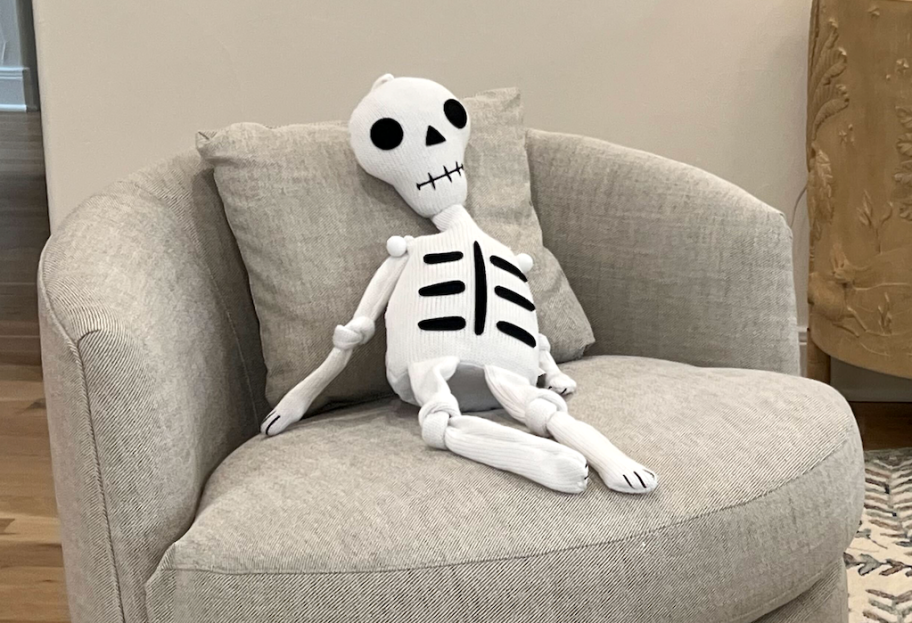 Knit skeleton sitting on a chair