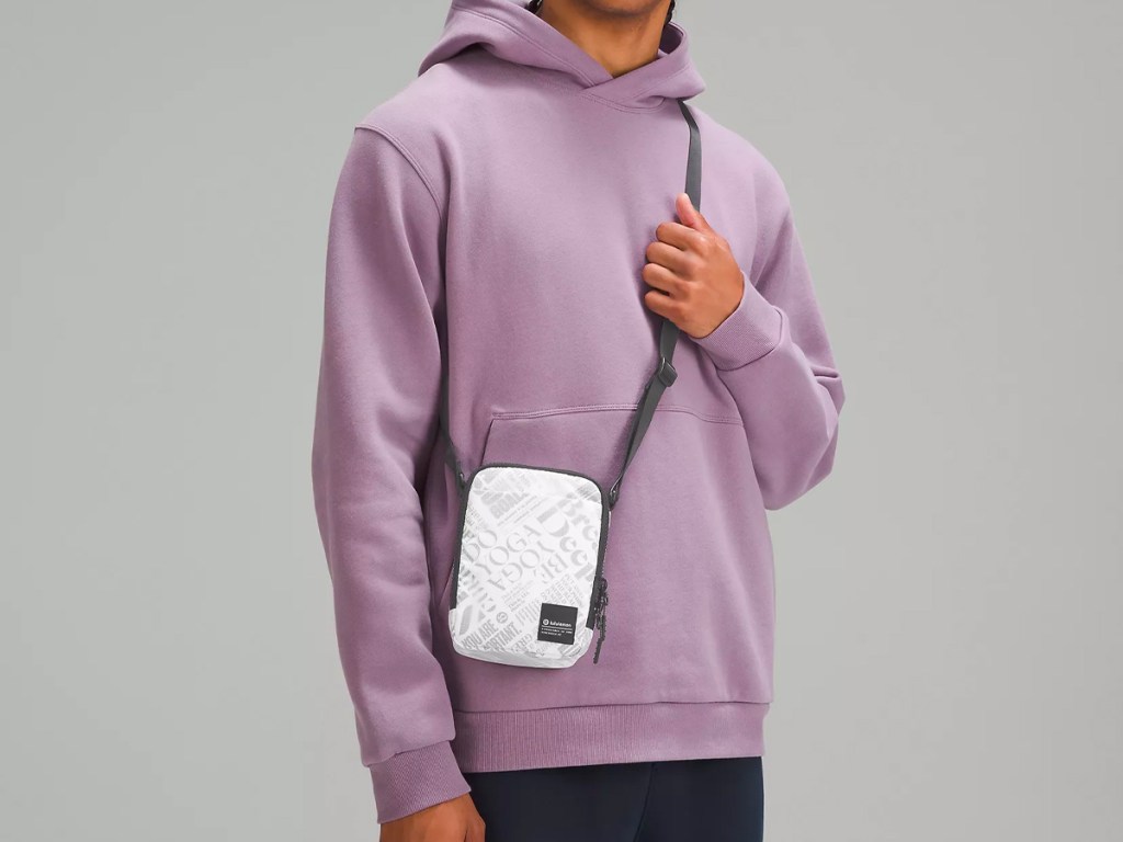 man wearing lululemon white and black crossbody bag