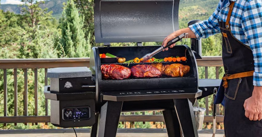 man grilling food in pit boss