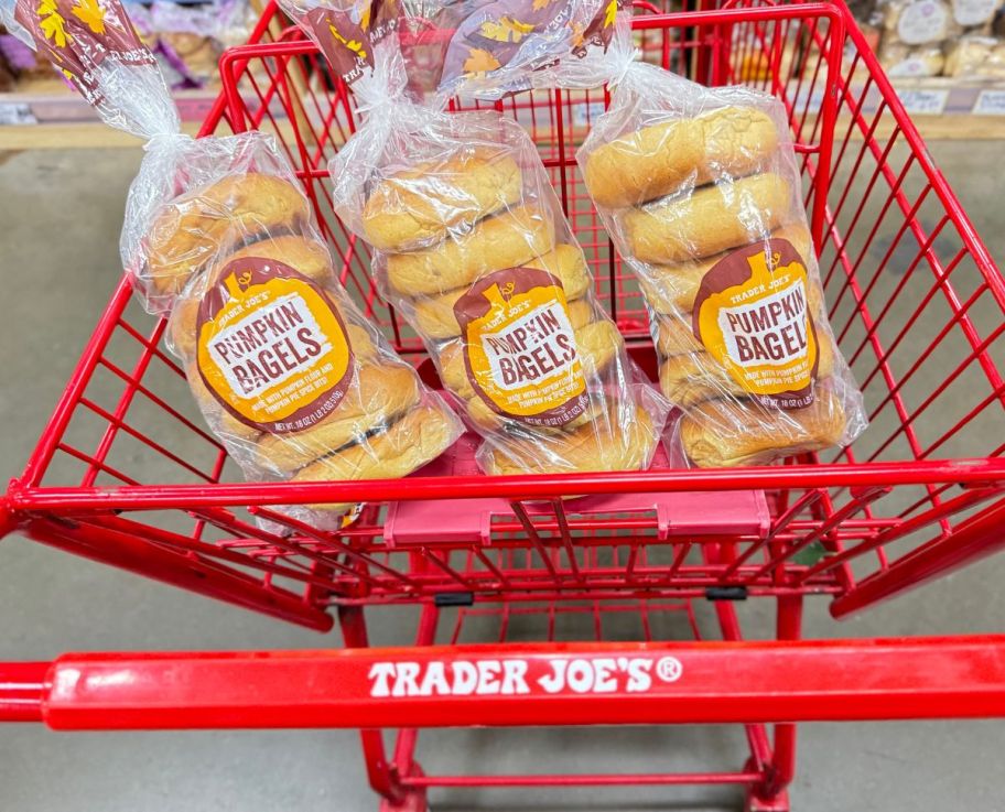 a shopping cart with 3 rolls of bagels in it.