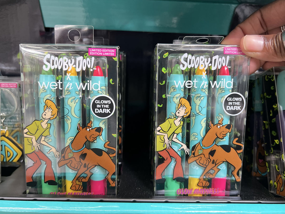 hand reaching for Wet N Wild Scooby Doo makeup face crayons pack