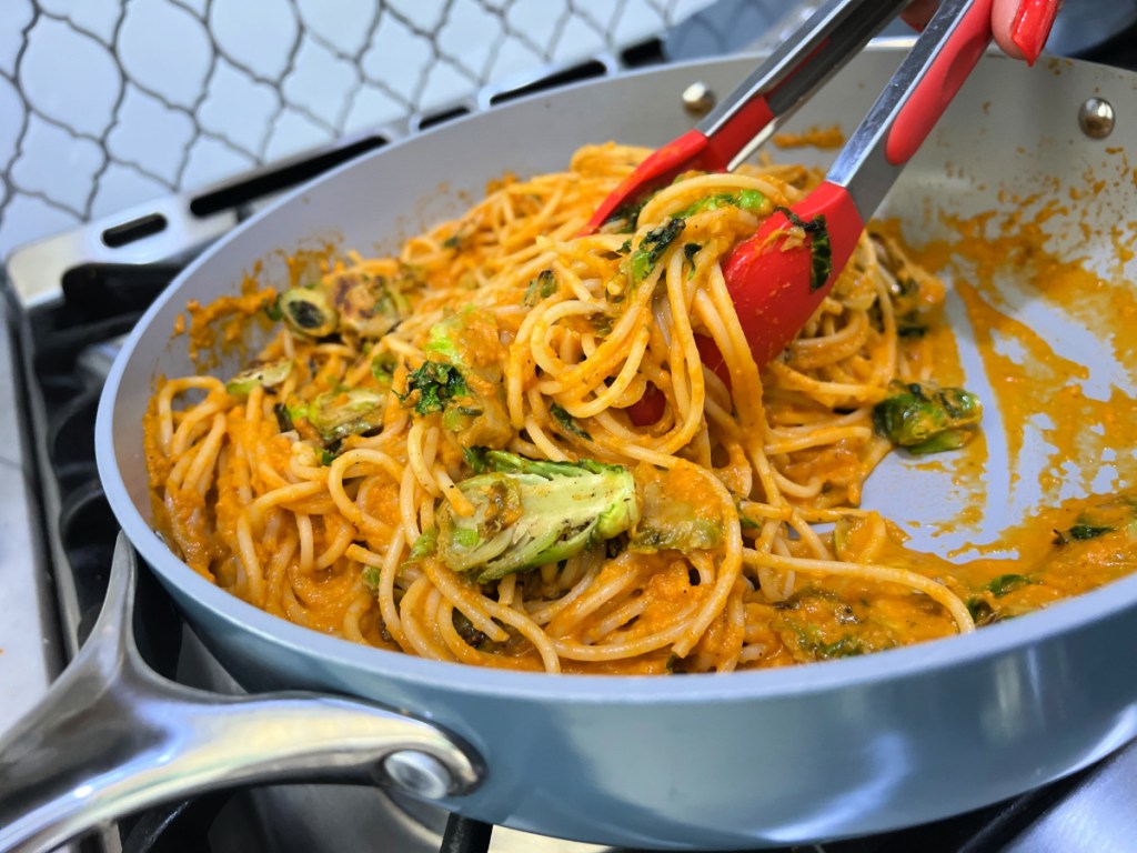 skillet tossing butternut squash pasta together