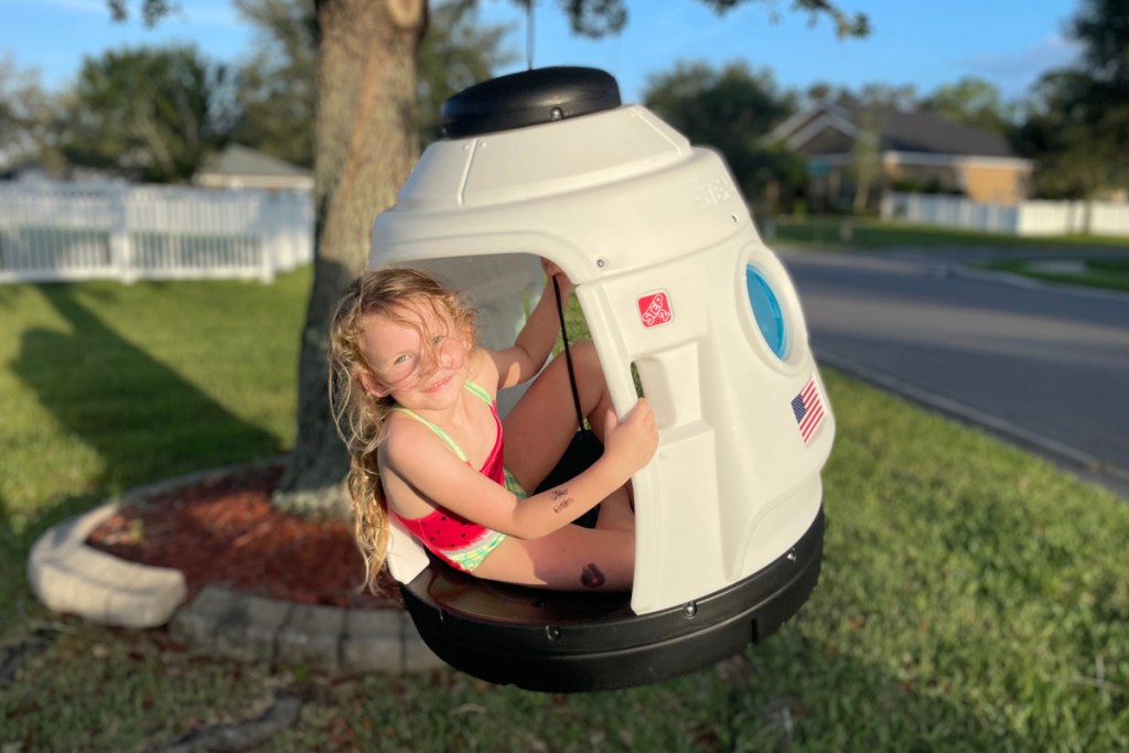 girl in rocket ship swing