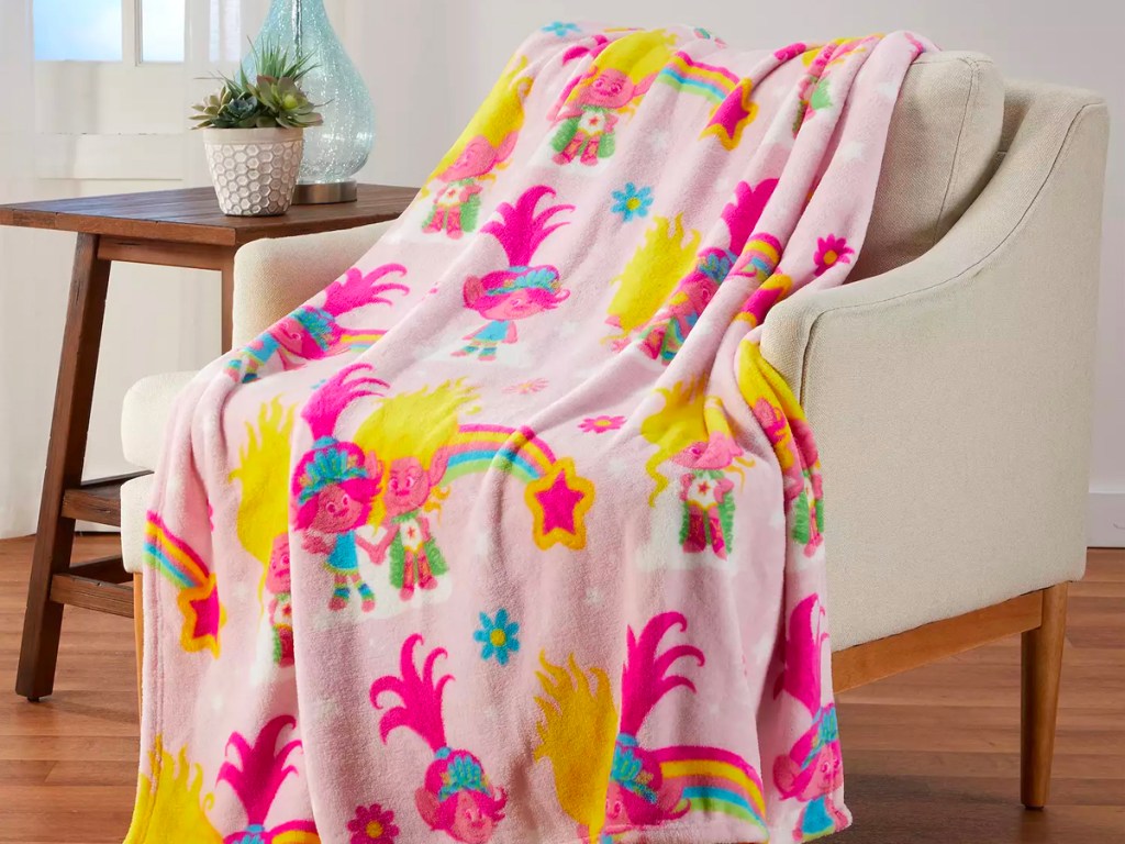 pink trolls blanket on beige chair