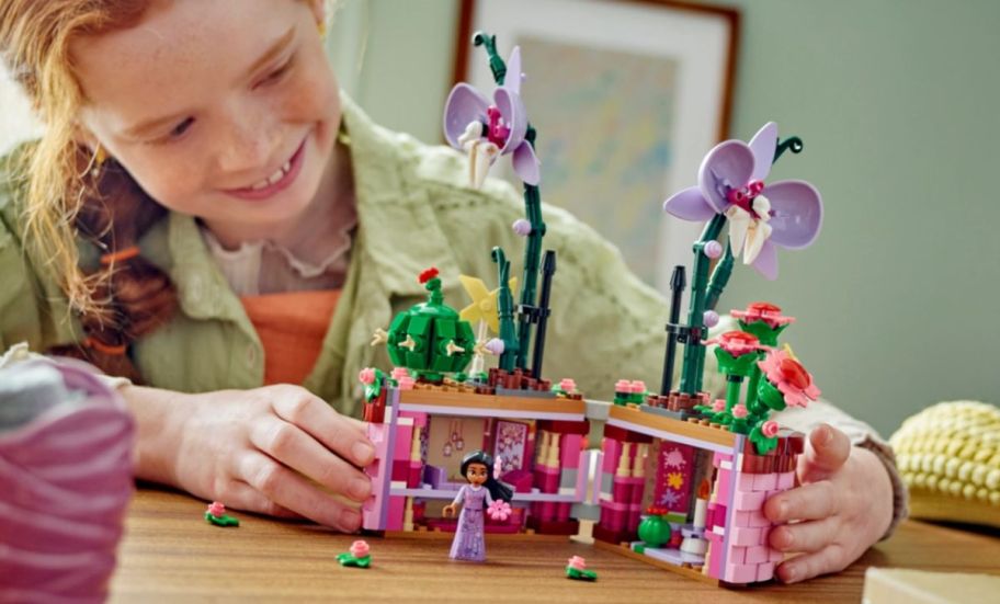 a girl playing with the orchid flower post building set