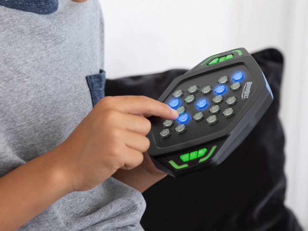 A person playing BrainBolt Genius Handheld Memory Game