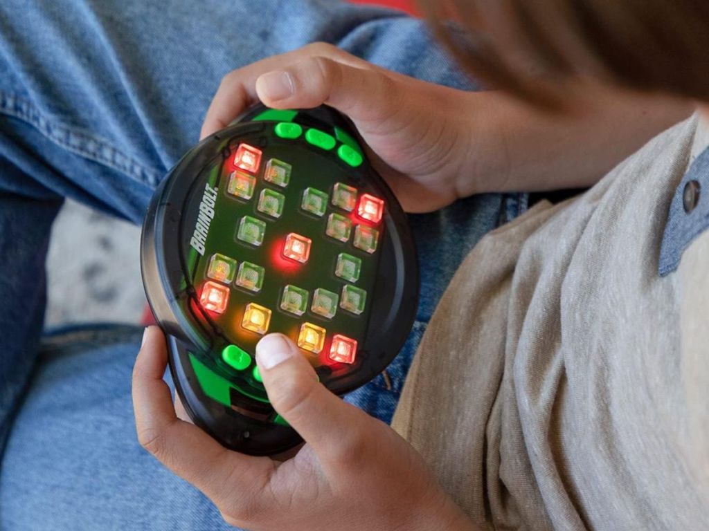 A person playing BrainBolt Genius Handheld Memory Game