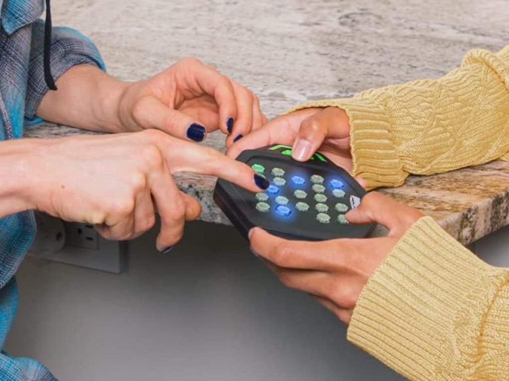 2 people playing a BrainBolt Genius Handheld Memory Game