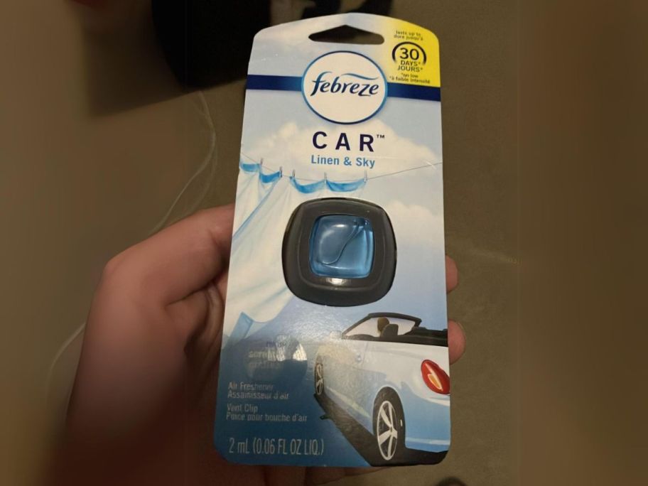 Febreze Car Air Freshener Vent Clip in Linen & Sky in hand