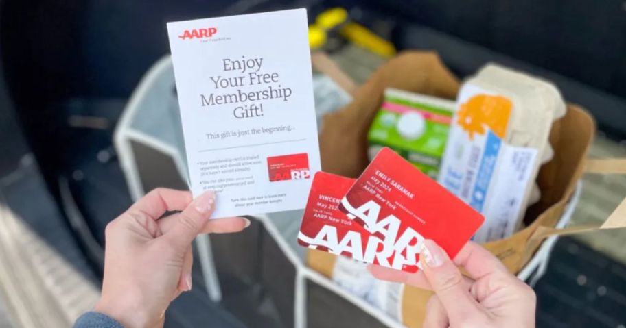 hands holding AARP Membership cards and welonlinee letter with the Free Trunk Organizer shown in the background