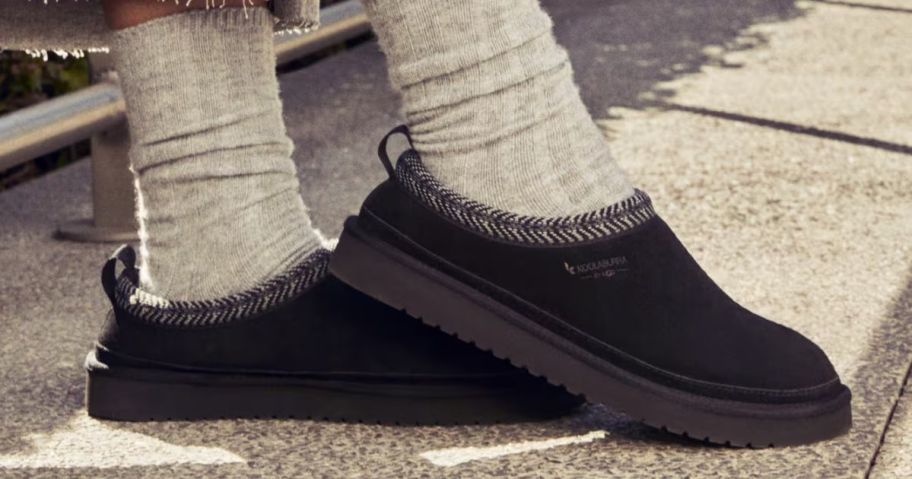 A person wearing a pair of Koolaburra by UGG Burree Women's Slippers in Black