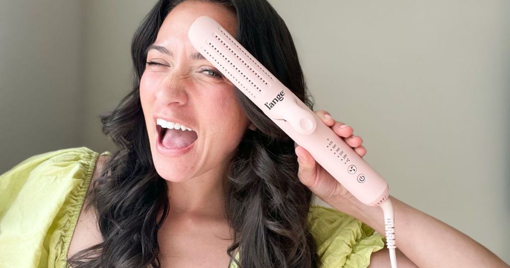 A woman holding a L'ange 360 Airflow Styler