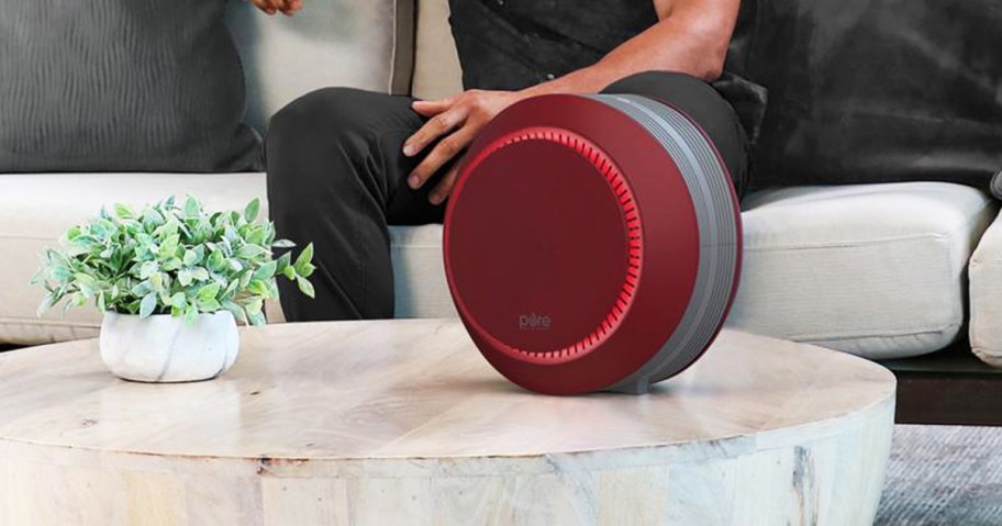 round red air purifier on coffee table