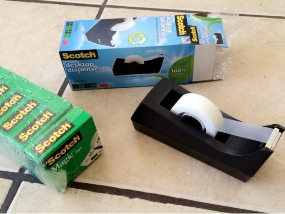 A scotch tape dispenser with 6 refill rolls of magic tape