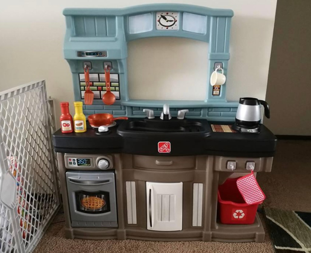 plastic kids play kitchen on carpet floor