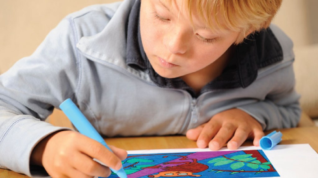 Child writing in a Studenttreasures Publishing Kit to beonlinee a published author