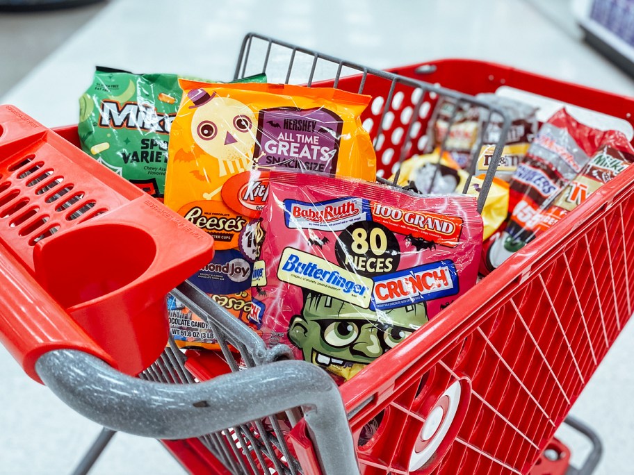 red target shopping cart filled with bags of halloween candy