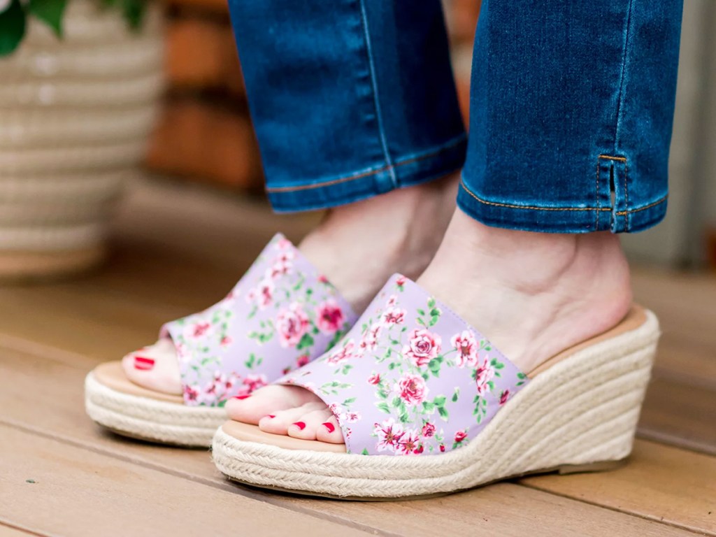 woman in jeans and pink floral print wedge sandals