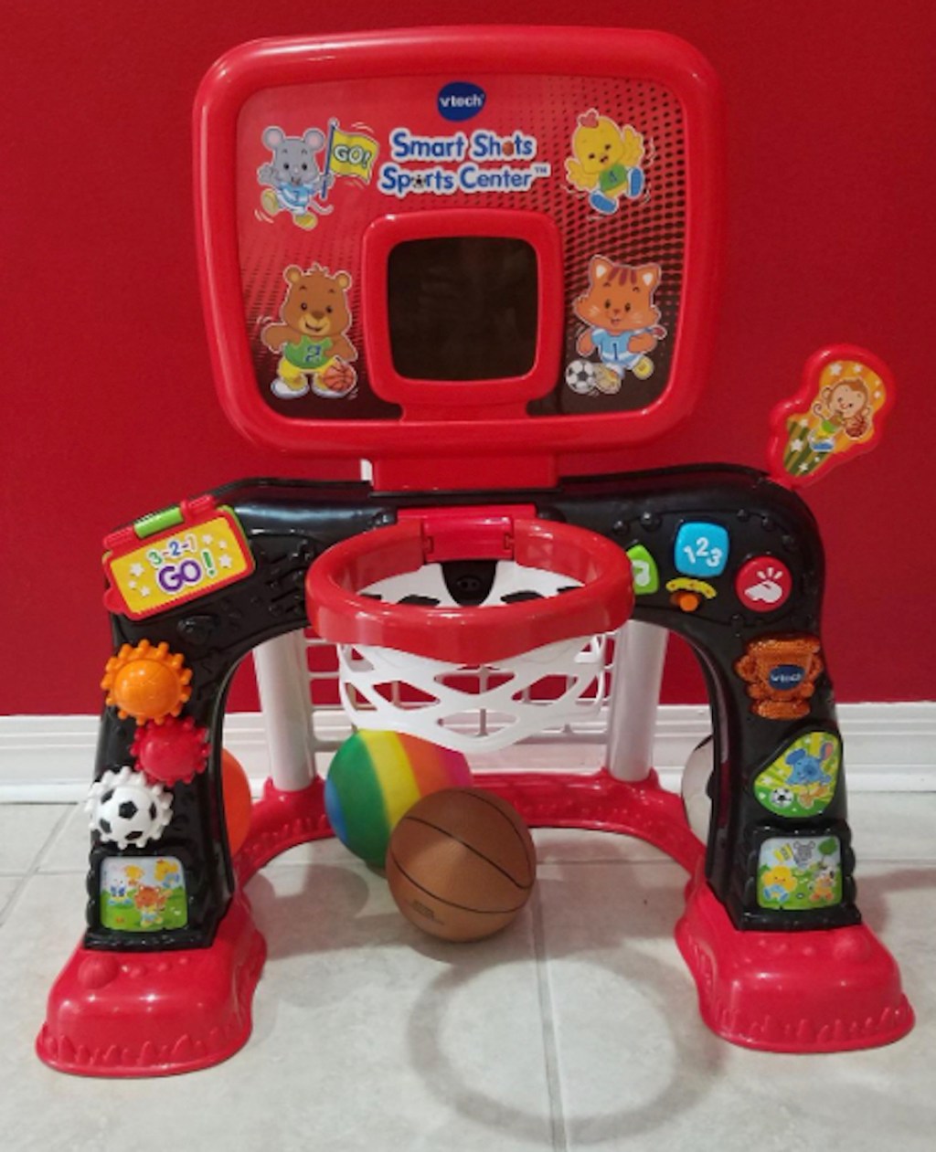 red mini basketball toy on floor in front of red wall