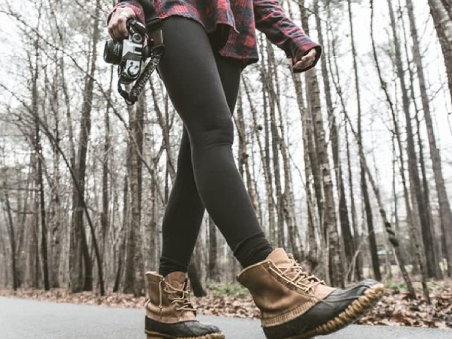 Woman-walking-with-fleece-leggings-and-boots-in-the-woods