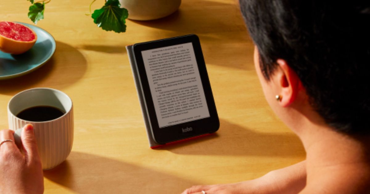 a woman drinking coffee while using a kobo ereader