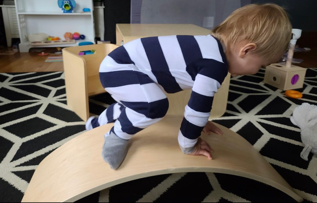 toddler on wood balance board best toys for 2 year olds