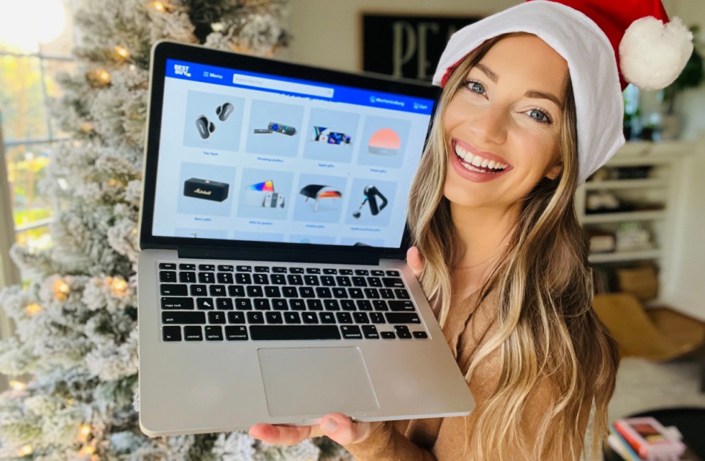 woman holding laptop showing best buy