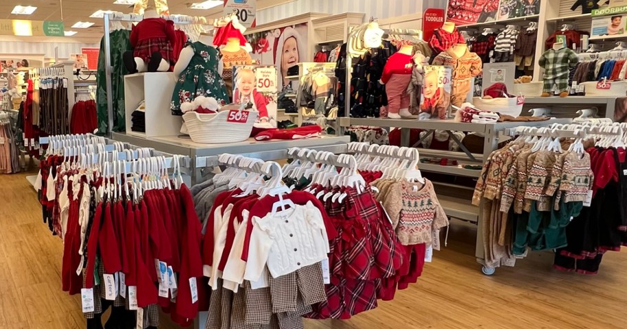 holiday clothes hanging in Carter's store