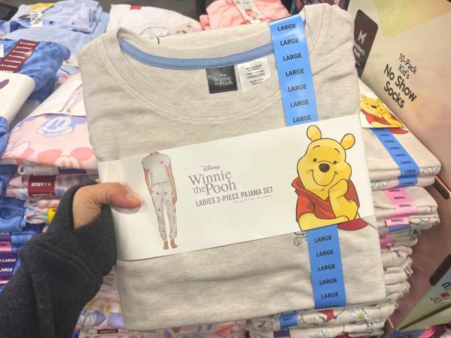 hand holding up winnie the pooh pj set