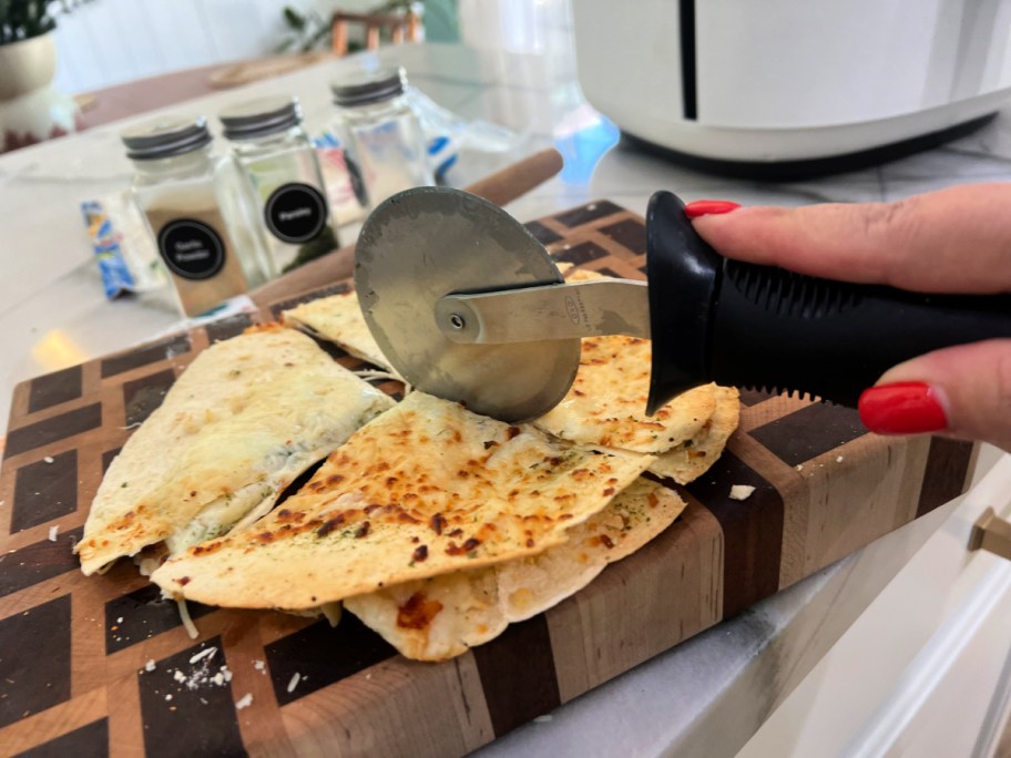 cutting a tortilla garlic bread slice