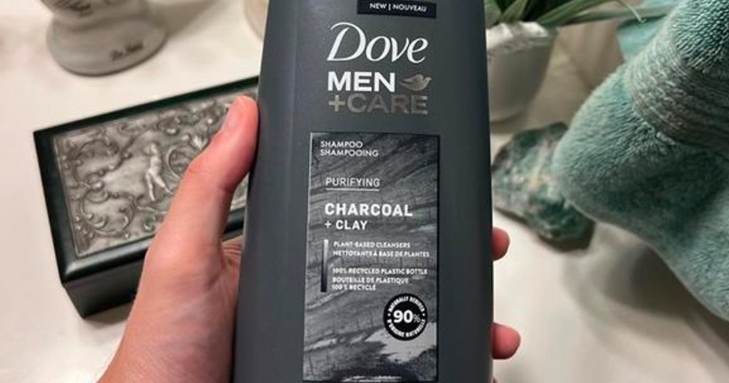 hand holding dove men care charcoal shampoo