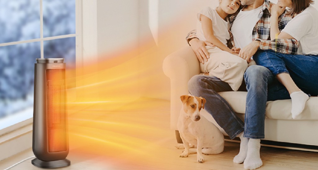 family sitting on the couch using the space heater with dog