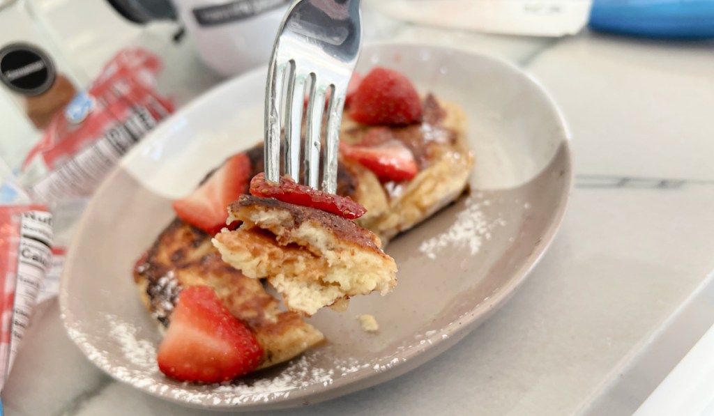 fork with uncrustables french toast and strawberries