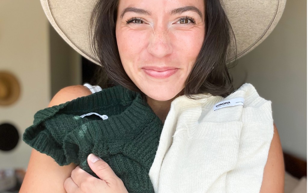 girl holding her favorite green and beige pullover sweater