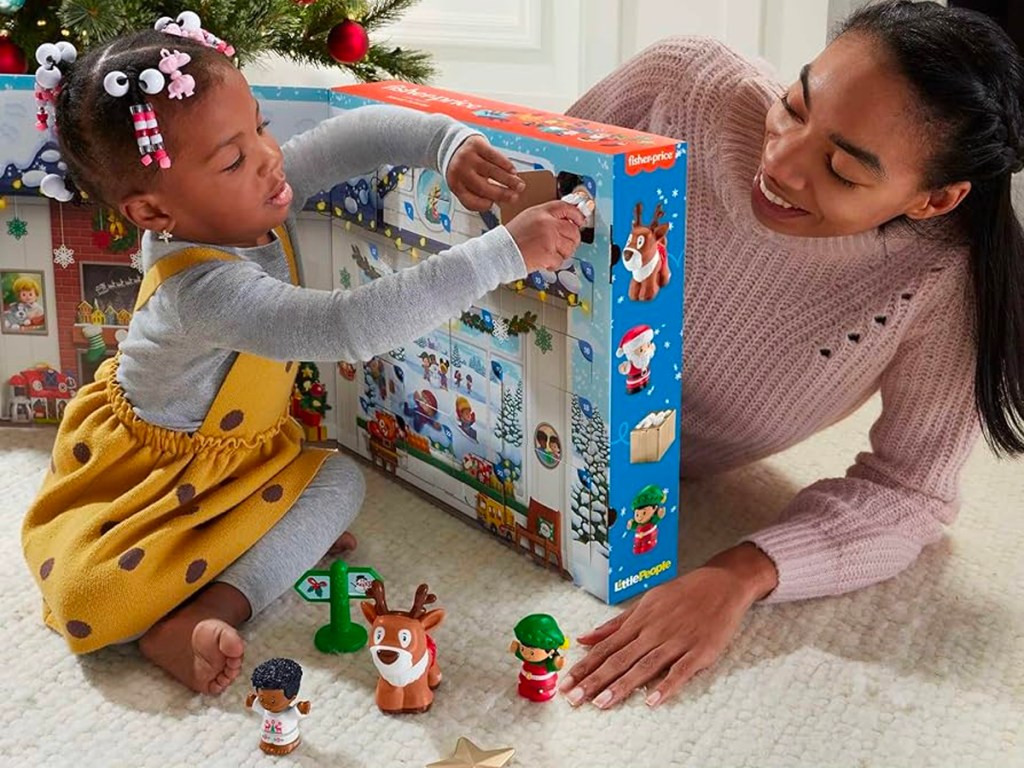 little girl opening advent calendar