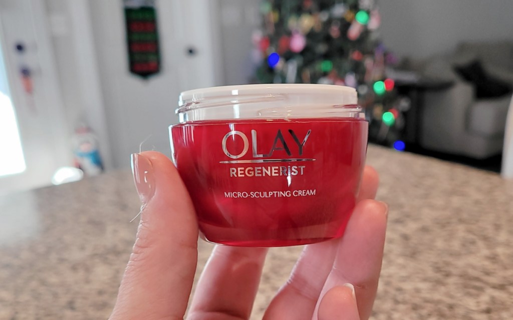 hand holding up a jar of Olay Regenerist moisturizer